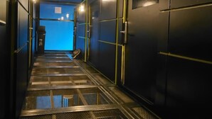 A corridor with a metal staircase leading to a room marked with the number 23. - Hostal Joy Calle 85 (Bogotá)