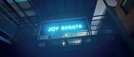 A building with a sign that reads "JOY BOGOTA".