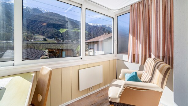 A room with a view of mountains, a radiator, a chair, and a table. - Studio Apartment 'Apartment Typ C Haus Pöder' with Mountain View (Naturno)
