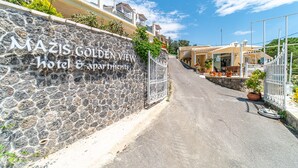 A stone wall with a sign for 'MAZIS GOLDEN VIEW hotel & apartments.' - Studio Apartment "Mazis Studio B2" with Sea View, Balcony & Wi-Fi (Corfu)