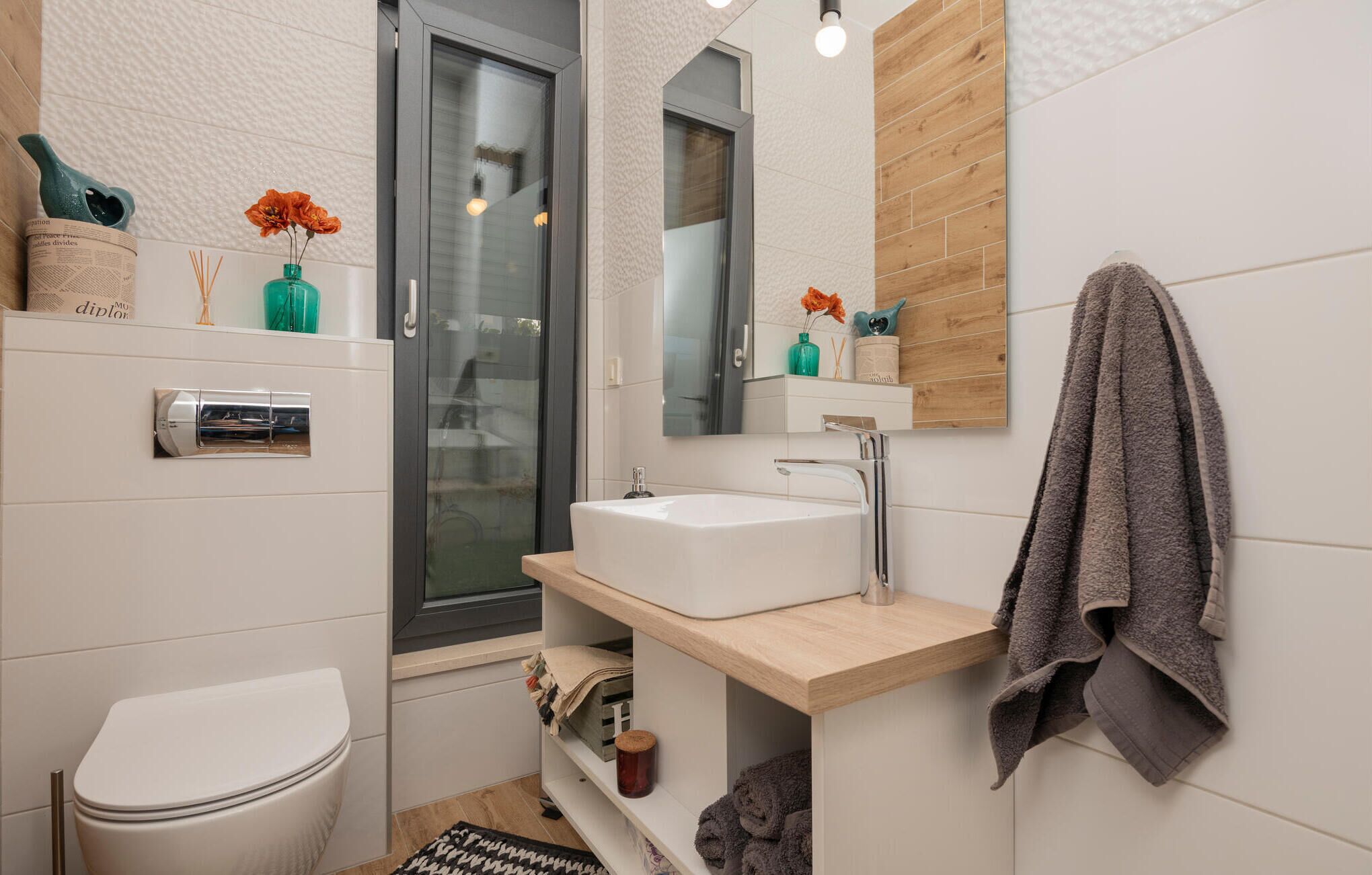 A modern bathroom with a toilet, sink, and shower.