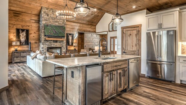 A spacious kitchen with a large island, wooden accents, and stainless steel appliances. - Mountain Brooks Retreat - Hot Tub | Close to Downtown Blue Ridge | Outdoor Fireplace (Blue Ridge)