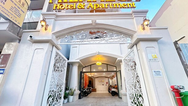 The entrance of MILANESA Hotel & Apartment with ornate white metalwork and a chandelier. - Milanesa Hotel & Apartment (Ho Chi Minh City)