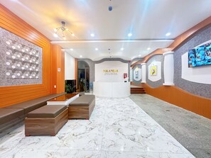 A hotel lobby with a reception desk, seating area, and a marble floor. - Milanesa Hotel & Apartment (Ho Chi Minh City)
