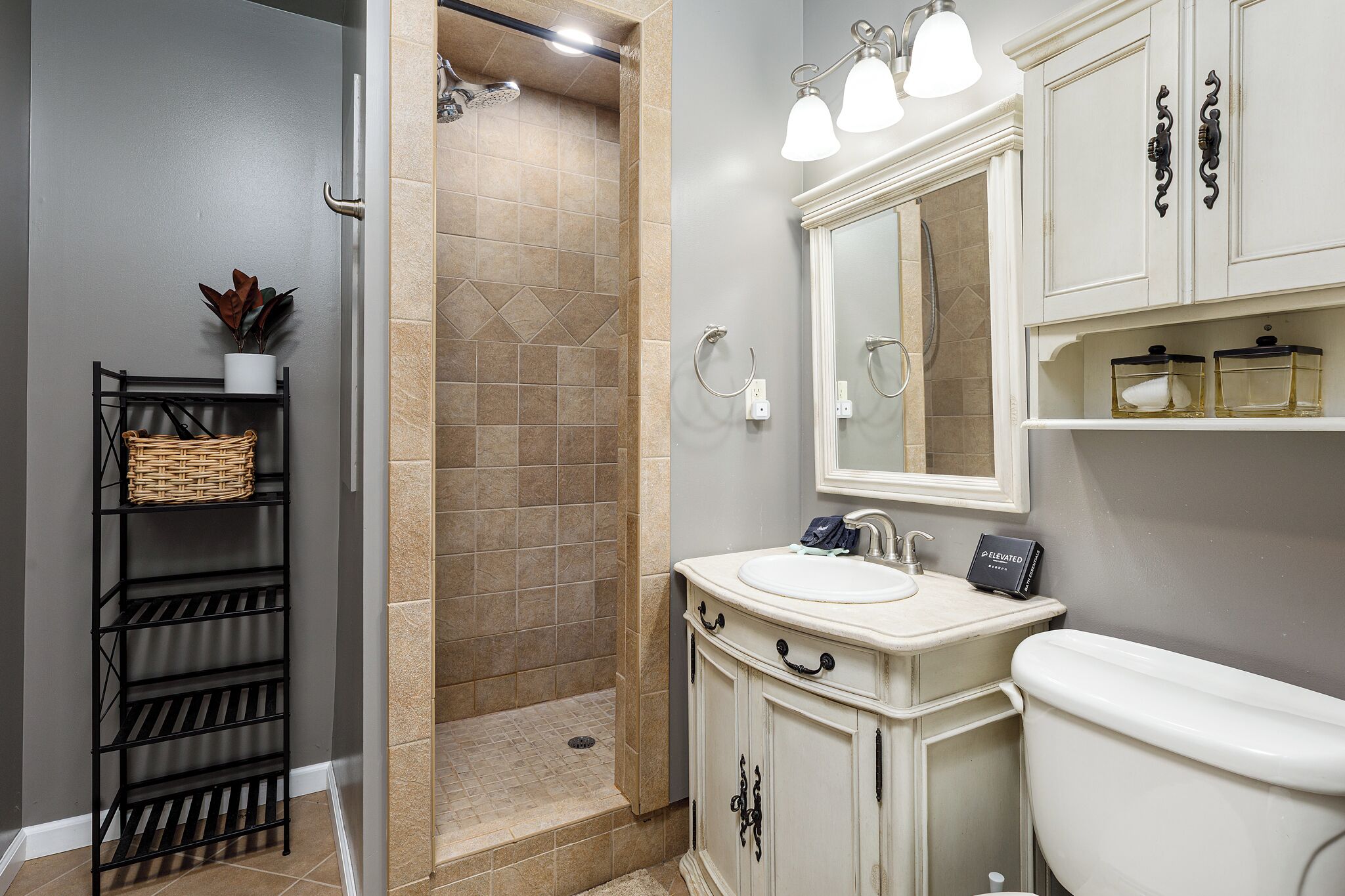 A bathroom with a shower, sink, and toilet.