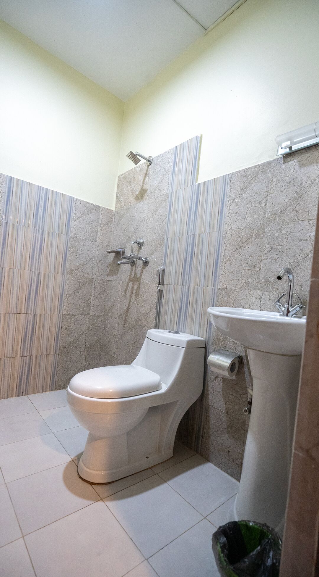 A bathroom with a toilet, a sink, and a shower.