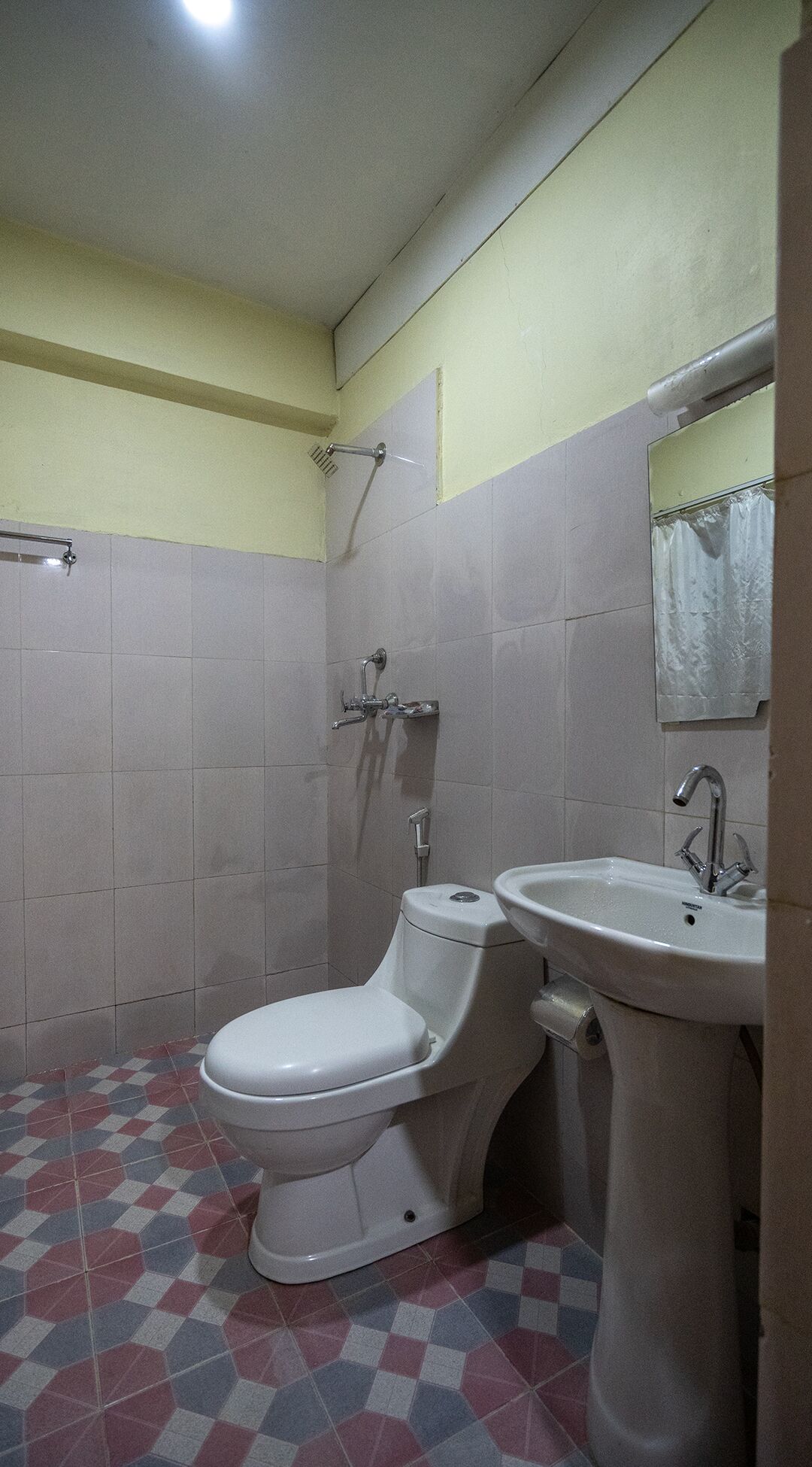 A bathroom with a toilet, sink, and shower.