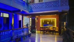 A multi-level residential building with balconies, potted plants, and a dining area with a table and chairs. - Hotel Shree Tara (Kathmandu)