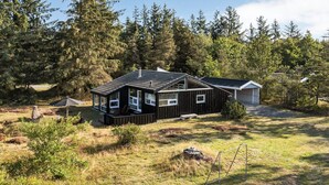 A cabin with a deck, surrounded by a forest. - "Immi" - 1.5km from the sea by Interhome (Saltum)