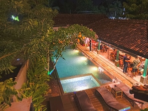 A rooftop pool area with a tiled deck, lounge chairs, and a bar area. - The Chariot Hikkaduwa (Hikkaduwa)