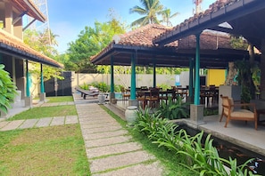 A courtyard with outdoor seating, a small pool, and lush greenery.