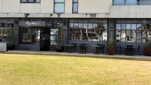 A building with a storefront labeled "Martha's" and a sign reading "GROCER" above the entrance. - Safety Beach Home - Walking distance to the beach and close to all amenities (Safety Beach)