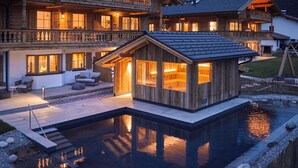A large wooden house with a swimming pool, multiple balconies, and a sauna. - Appartement Alpstyle Family (Reit im Winkl)