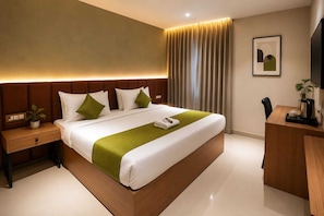 Una habitación de hotel moderna con una cama grande, una mesita de noche, un escritorio y una silla.
