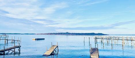 A calm lake with wooden docks extending into the water.