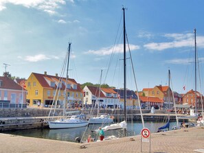 A marina with colorful buildings and boats docked.