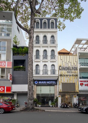 A hotel with a modern facade, large windows, and a visible entrance. - Mari Queen Hotel - Bui Thi Xuan (Ho Chi Minh City)