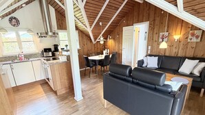 A modern interior with a kitchen, dining area, and seating space. - "Gretta" - 400m from the sea by Interhome (Dannemare)