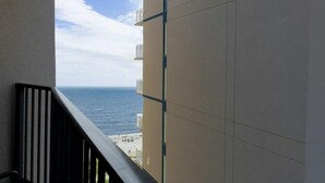 A balcony with a view of the ocean and beach. - Spacious Luxury 12th Floor Resort View King Suite (Myrtle Beach)