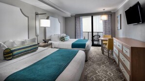 A hotel room with two beds, a desk, a chair, a TV, and a balcony with curtains.