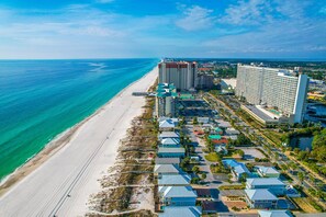 An aerial view of a coastal hotel with multiple buildings, a beach, and a pier. - Blue Heaven on the Beach, Gulf-Front Luxury for Large Groups, Private Pool (Panama City Beach)