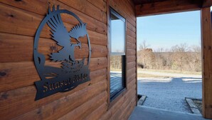 Une cabane en bois avec une plaque en métal portant l’inscription « Sunset Ridge ».