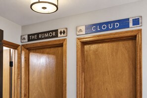 Two wooden doors with signs above them, one labeled 'THE RUMOR' and the other 'CLOUD'.