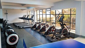 A gym with treadmills, stationary bikes, and elliptical machines. - Lux Suites Gold Park Apartments Kilimani (Nairobi)