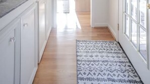 A hallway with white cabinets, a marble countertop, and a patterned rug. - Private, Serene Mt Lookout 5B Retreat w/Garage & EV Charger (Cincinnati)
