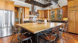 A spacious kitchen with a large island, stainless steel appliances, and wooden cabinetry. - Gorgeous Private Home with Breathtaking Views of Red and Buffalo Mountain! (Silverthorne)