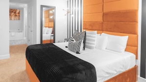 A modern bedroom with a large bed, a mirror, and a striped wall. - Palm Bay Retreat: Pool, Amenities & Free Parking
 (Palm Bay)