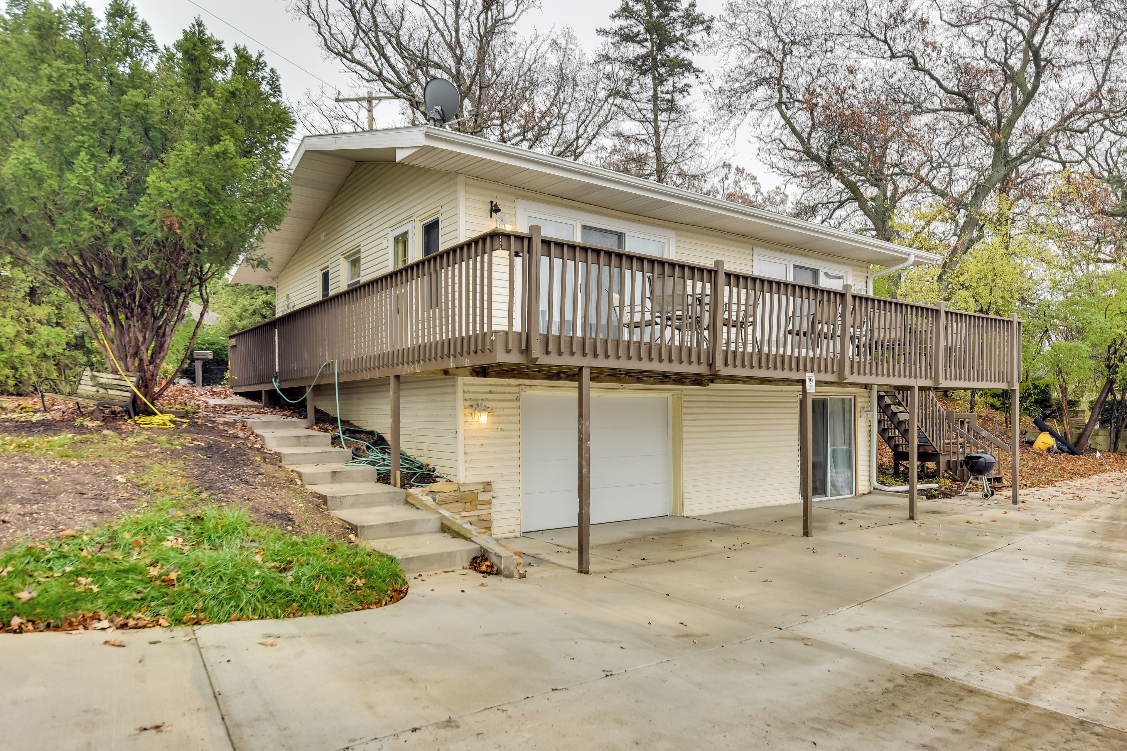 A two-story house with a covered front porch and a garage.