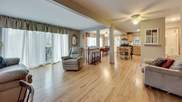 A spacious living room with a wooden floor, a dining area, and a kitchen in the background. - Salem Vacation Home w/ Dock: Steps to Paddock Lake (Salem)