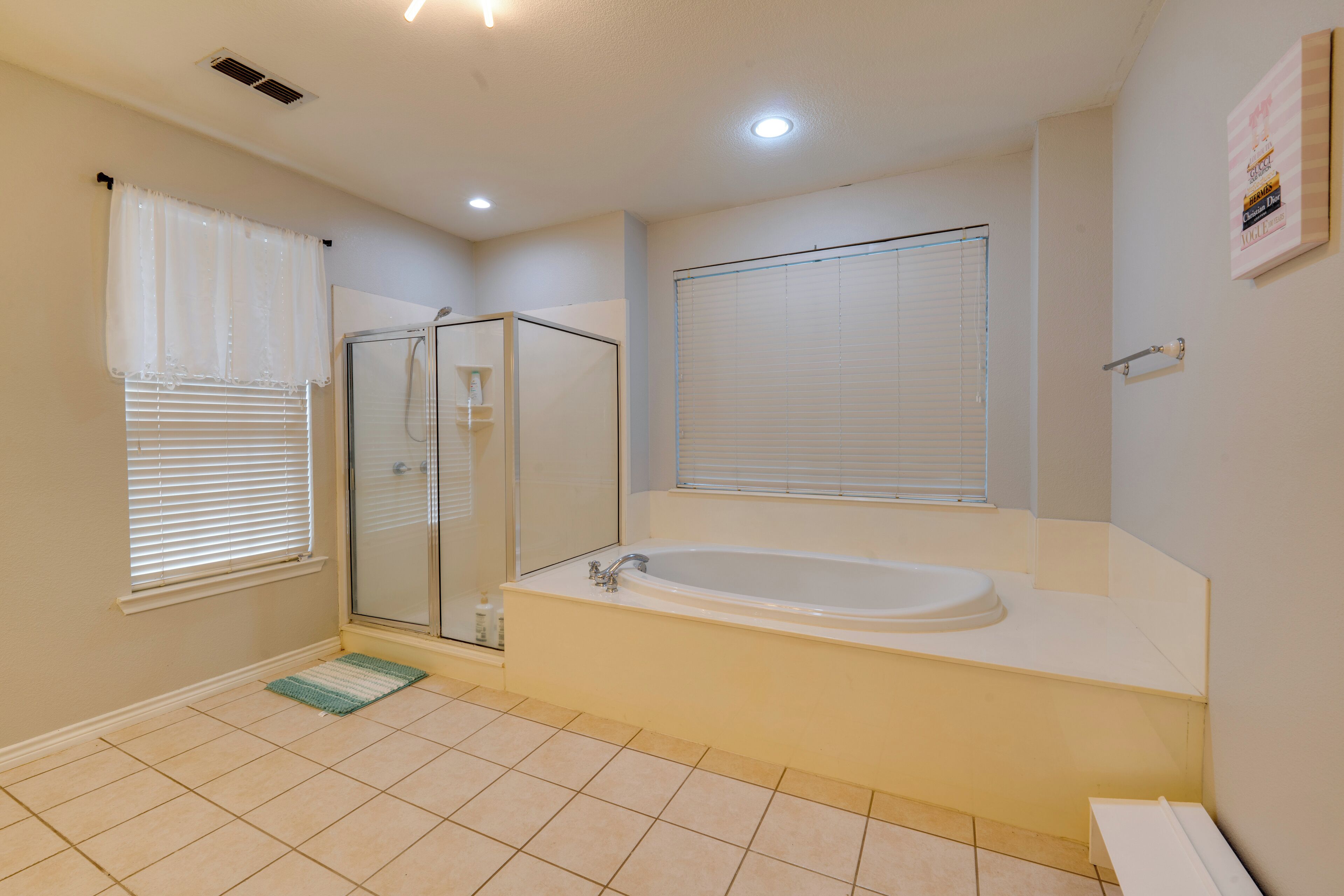 A bathroom with a bathtub, shower, and toilet.