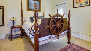 A bedroom with a four-poster bed, a wooden headboard, a small bedside table, a lamp, a rug, and a painting on the wall. - Charming Ogden Vacation Rental: 2 Mi to Downtown (Ogden)