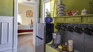 A kitchen with a refrigerator, coffee maker, and various kitchen utensils. - Charming Ogden Vacation Rental: 2 Mi to Downtown (Ogden)