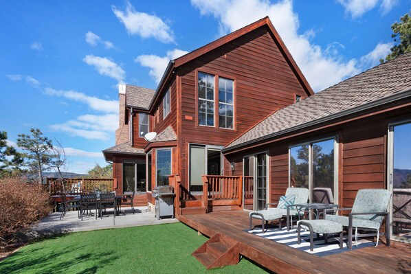Enjoy the expansive deck with comfortable seating and take in the serene views of the well-manicured lawn.