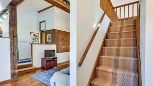 A staircase with a patterned carpet and wooden railings.
