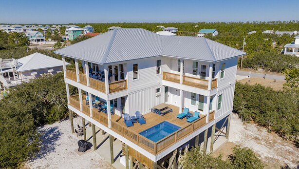 A two-story beachfront house with a pool, balconies, and a deck. - Luxury Coastal Escape | Heated Pool | Golf Cart Included (Gulf Shores)