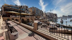 A waterfront promenade with a café named 'Cuba' and 'Lore & Fitch' restaurant.