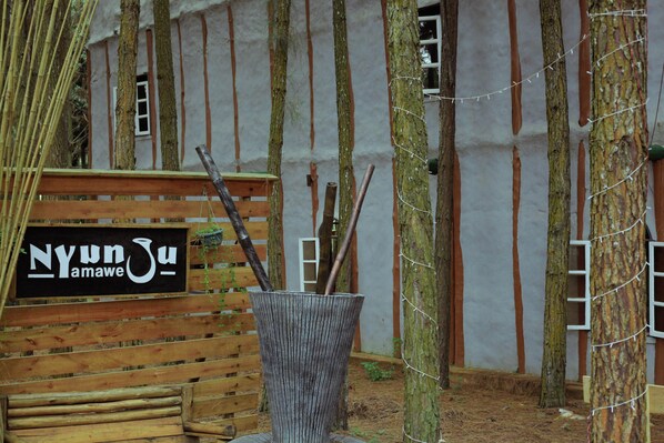 A rustic wooden bench with a sign reading "Nyunyu Amawe." - Nyungu Yamawe Forest Park (Kitukutwe)