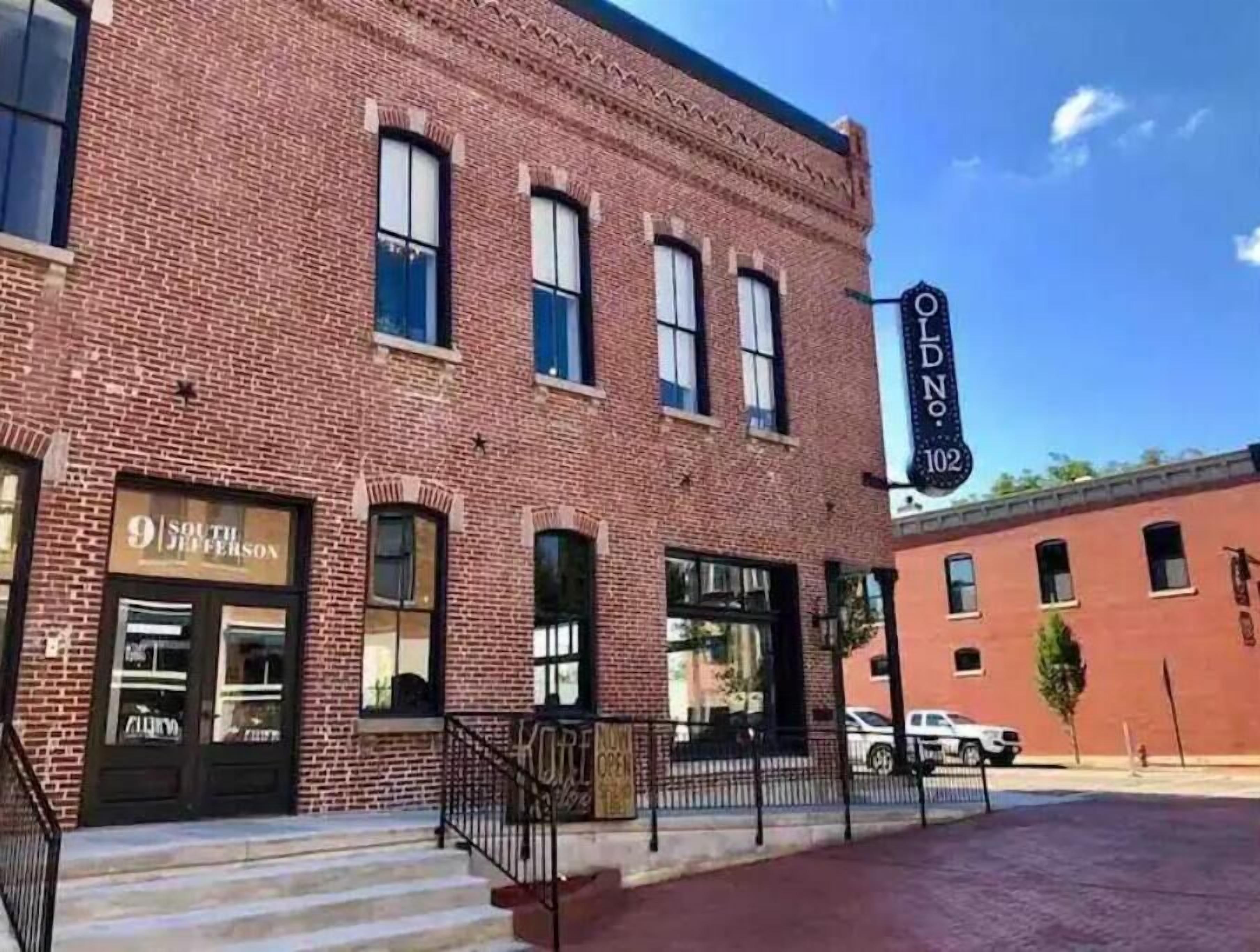 A brick building with a storefront labeled "9 South Jefferson."
