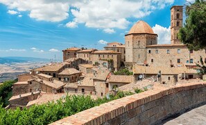 Experience the charm of a historic town with a prominent church and traditional stone buildings.