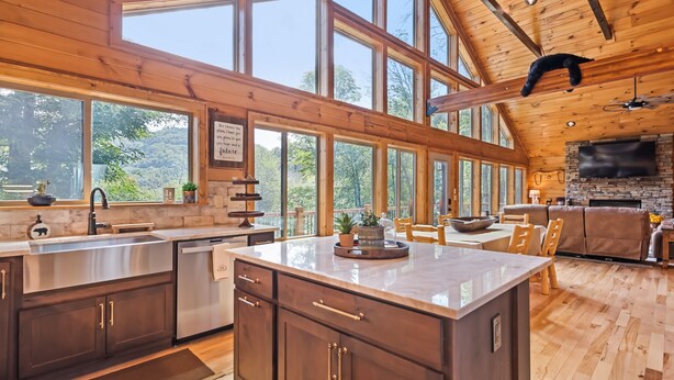 A spacious kitchen with large windows, wooden cabinets, and a central island. - Black Bear Ridge! Newly Built! 4BD/3.5 BA (Maggie Valley)