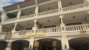 A multi-story building with a cafe bar on the ground floor, marked by a sign. - Cinema Stay inside Intramuros Manila by IN CAFE (Manila)