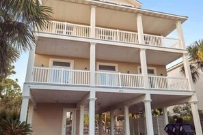 A two-story building with a balcony on the upper floor. - Reel Time  6 BD St George Island, FL Vacation Re (St. George Island)