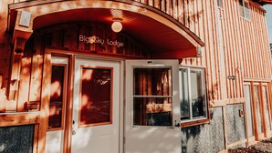 A wooden building with a sign reading "Big Sky Lodge" above the entrance. - Relax in "Big Sky" Style just 3 blocks from the Symes Mineral Soaks! (Hot Springs)