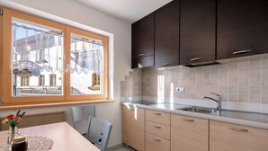A modern kitchen with a window, a sink, and wooden cabinets. - Farmhouse 'Innerjerberhof Sunnseit' with Mountain View, Shared Terrace and Wi-Fi (Laurein)