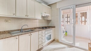A kitchen with a sink, stove, oven, and cabinets. - Apartment 'Castillo De Mar F3 Torre Sur 2a' with Sea View, Shared Pool and Wi-Fi (La Manga del Mar Menor)