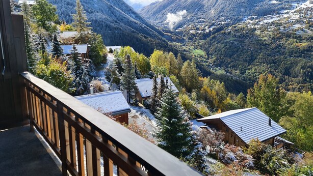 A mountain cabin with a wooden deck, surrounded by snow-covered trees and a valley. - Greppons N 012 - MOUNTAIN apartment 6 pers (Veysonnaz)